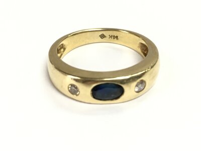 A 14ct gold ring set with diamonds and a sapphire. Size N and 4.53g