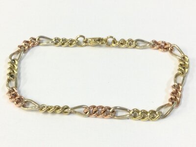 A 9ct gold tri tone bracelet, 9cm wide. 8.7g