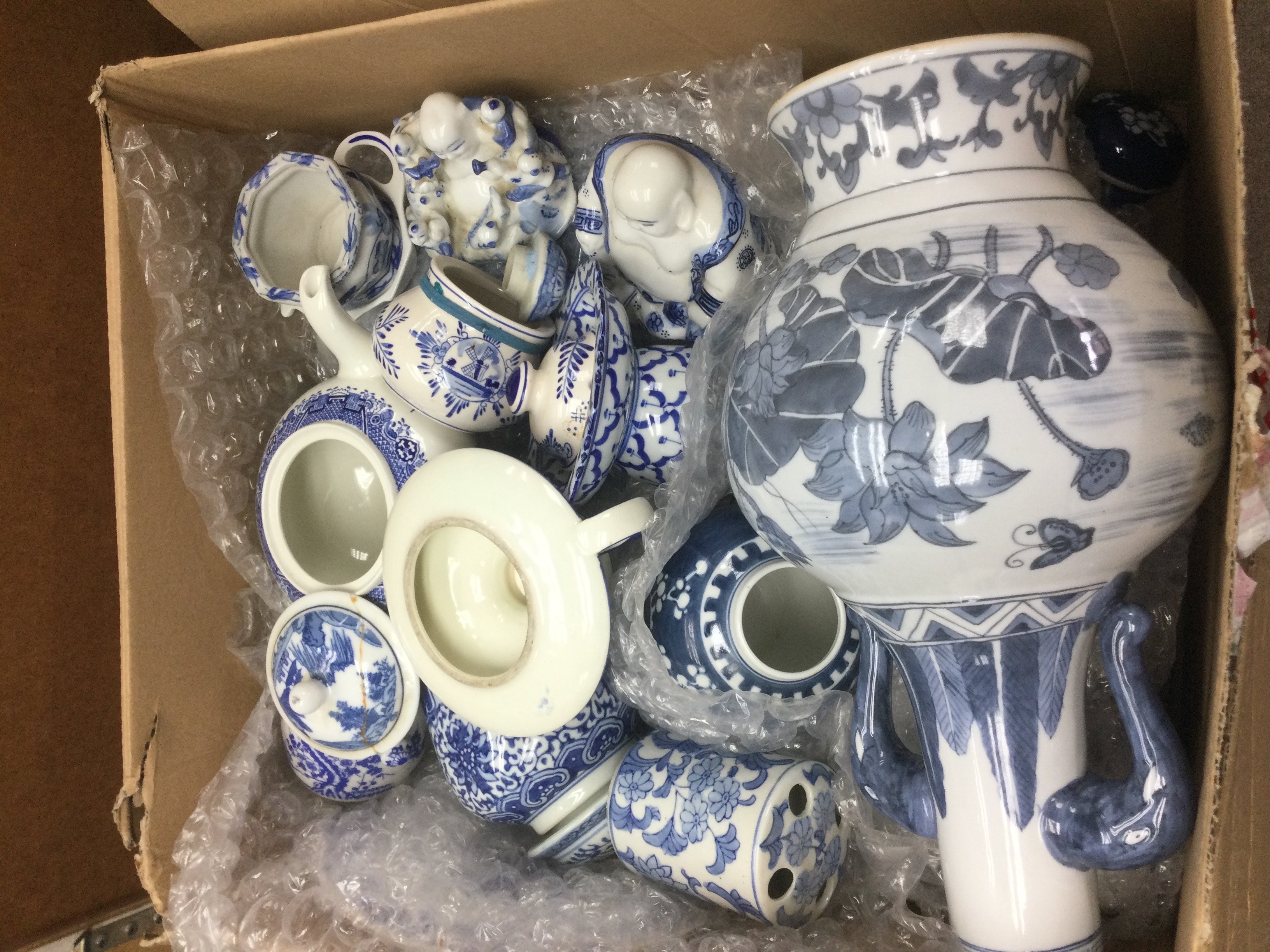 Four boxes of mainly blue and white ceramics. Shipping category D.