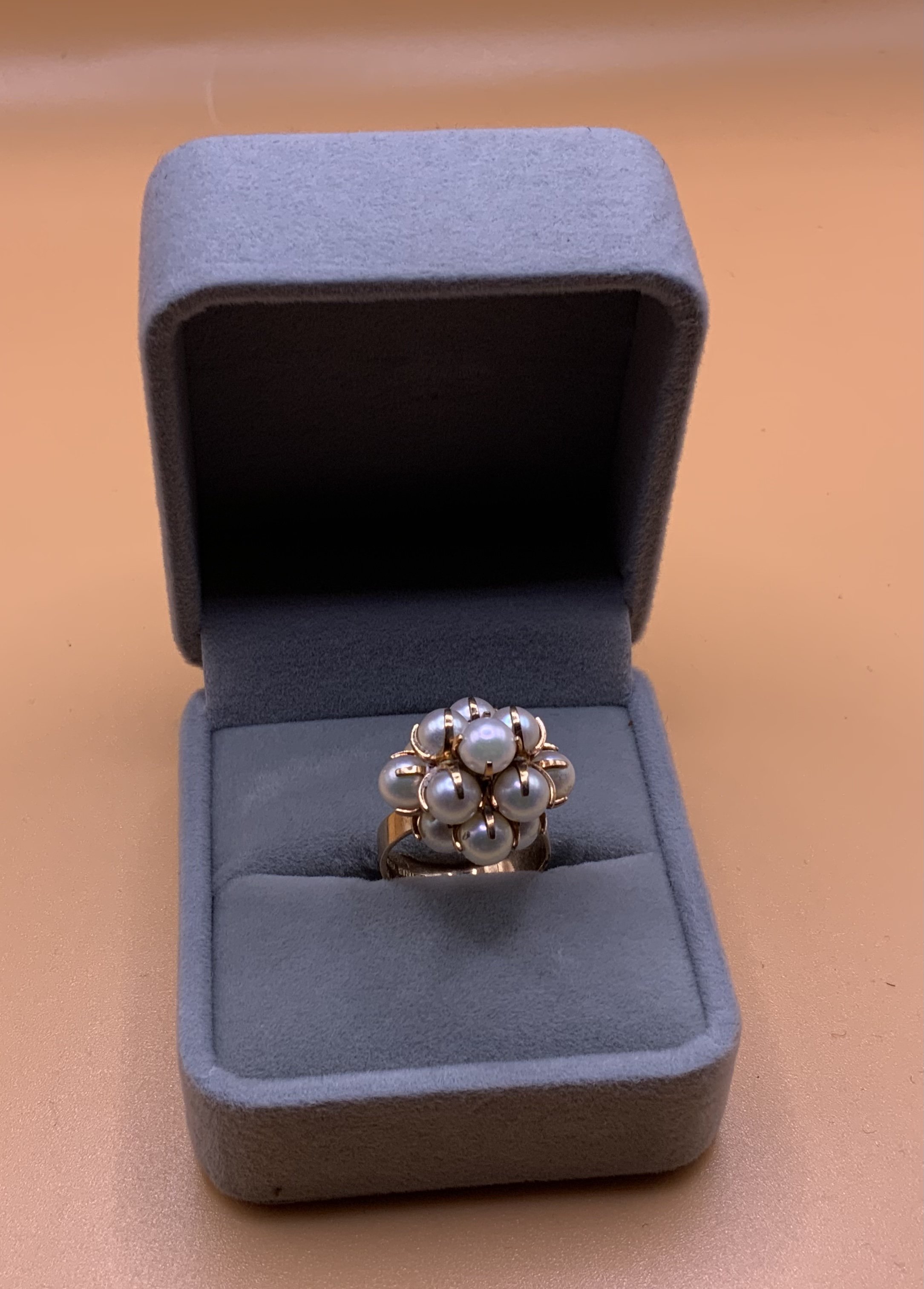 A 14ct gold and pearl set cluster ring. Size M.