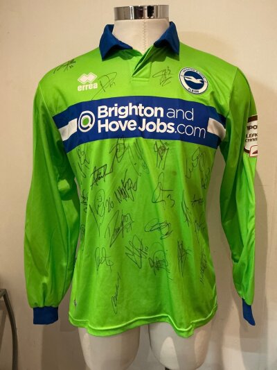 Brighton Match Prepared Multi Signed Football Shirt: Green Goalkeeper shirt with number 40 East to rear signed by 24 players to front and the goalkeeper to rear. East was on loan to Brighton during the 2012 - 2013 season.