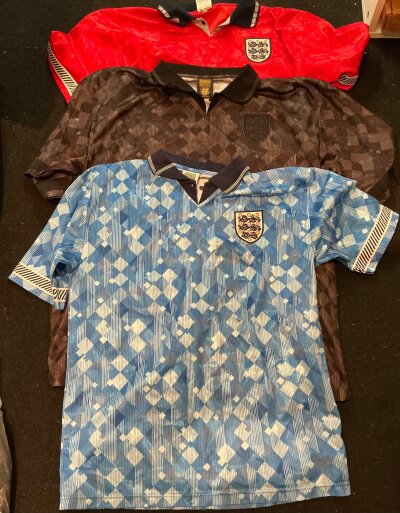 England Reproduction Football Shirt Collection: Nine different shirts in adult sizes made by score draw and toffs in good condition. (9)