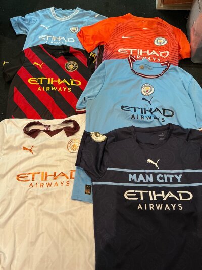 Manchester City Football Shirt Collection: Four adult and two child shirts in good condition with 5 having names and numbers to rear. (6)