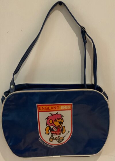 England 1966 World Cup Willie Football Shoulder Bag: Excellent condition vinyl bag with adjustable shoulder strap. Rarely seen as item produced by the German company Schuster. Measures approximately 15 x10 inches