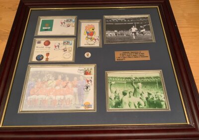 1966 World Cup England Signed Football Display: Autographed Editions large first day cover with winning team pictured signed by 10 of the players excluding Bobby Moore. Separate first day covers signed by Moore and Ramsey. A photo of the 4th goal signed by Kenneth Wolstenholme with the famous “they think it’s all over” quote written. A World Cup Willie first day cover and badge Nicely framed measuring 28 x 26 inches. COA from reputable source.