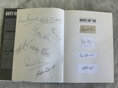 England 1966 World Cup Winners Signed Football Book: Boys of 66 by Martin Tyler hand signed by all 11 winning players plus Alf Ramsey. Please note Peters J Charlton Stiles Hunt Hurst Wilson Cohen and Banks have signed inner blank page of book with Ball Ramsey B Charlton and Moore having had autographs stuck in.