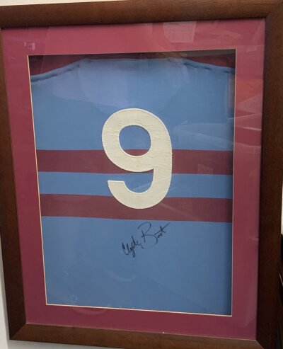Clyde Best West Ham Match Worn Football Shirt: Iconic light blue away shirt with two claret hoops. This number 9 shirt has been signed by Clyde under the number and has been framed. We and staff members of gamewornfootballshirts have made necessary checks and can confirm its authenticity.. The number is exactly the same style as Alan Taylor’s number 9 and has been sewn in identically. The material is correct and whilst it is framed we managed to open a small bit at the back and can confirm we saw the Bukta Zeebux black label. We believe this would take a while to remove from frame so is sold within frame.