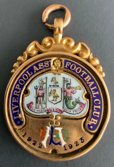 Liverpool 1922 - 1923 League Winners Football Medal: Issued by the club to Director Walter Cartwright. Stunning design of club badge to front in enamel stating Liverpool Ass Football Club 1922 - 1923 with rear engraved Liverpool Champions W H Cartwright Director Division 1 with gold hallmark underneath. It is believed the players got one of these also. 22ct Vaughtons medal weighing 22 grammes.
