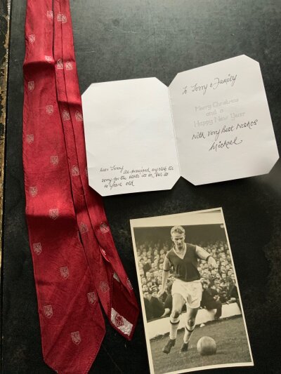 Mike Grice West Ham Football Tie: Mikes original tie he wore on official duty from 1955 to 1961 with hammers crest throughout the claret tie. C/W a Christmas card from Mike stating the tie is enclosed and a small press photo of him in action in 1957. (3)