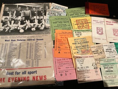 West Ham Football Memorabilia Box: Must view with tickets, reserve programmes, coin sets and a lot more. Large 64/65 Evening News fixture list on board featuring the cup winning team of 64. There are fixture lists, season ticket, England coin sets, newspapers from cup finals/England 1966 with a 1966 World Cup commemorative medal. There are nearly 30 small reserve and youth sheets mainly from the 60s and some big match and European tickets. Nice lot.