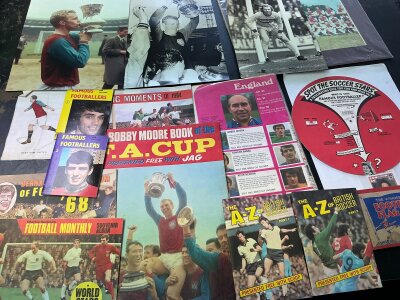Football Memorabilia Box: Includes some nice West Ham West Ham items, press photos to include Bobby Moore, many items presented with magazines including Victor, Wizard, Hornet, Champion, Jag + Charles Buchan. Unused Lion league ladders and uncut teams.