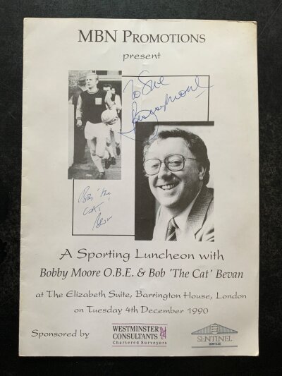 Bobby Moore Signed Football Menu: 1990 Luncheon with Bobby Moore and Bob The Cat Bevan. Signed to front by the cat with a dedicated to Sue autograph of Bobby Moore.