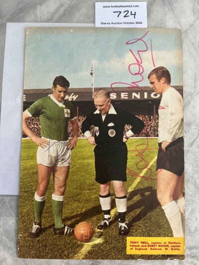 Bobby Moore Signed England Football Picture: Full size colour magazine picture of captains Moore of England and Neill of Northern Ireland. Both have signed with Bobbys being a large clear autograph in pink. And Neil’s in blue biro. UACC backed COA.