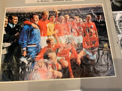 England + West Germany Fully Signed 1966 World Cup Scrapbook: Original 1966 World Cup scrapbook. 22 pages have a signed magazine picture of an England squad player in often their club kit and an original cigar band of the 11 that played in the final. There is a page which has autographs of Ramsey Shepherdson and Cocker. There are newspaper reports on the England matches and at the end there is a team group fully signed by the winning team plus autographs of the whole German team. Very nice item.