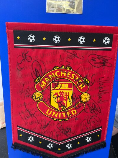 Manchester United Signed 2001 - 2002 Football Pennant: Previously framed and now stuck to card from a reputable source. Includes signatures of 16 players notably Beckham Butt and both Nevilles. C/W an undedicated signed hardback book of Christiano Ronaldo.
