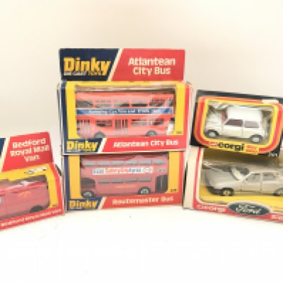 3 Boxed Dinky Toys a Bedford Royal Mail Van #410. A Atlantean City Bus #291. A Routemaster Bus #289. And 2 Corgi Toys a Ford Sierra #299 and a Mini 1000 #201.