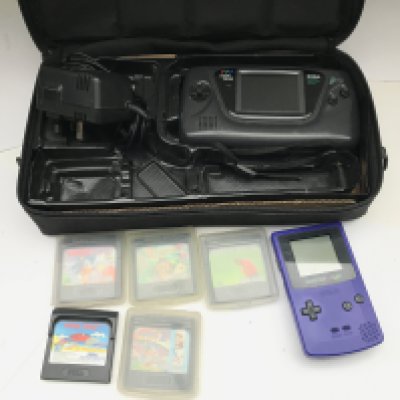 A Seaga Game Gear With Games and a Nintendo Game Boy Color.