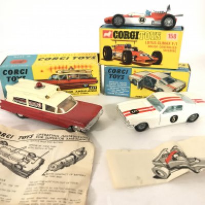 A Boxed Corgi Superior Ambulance #437. A Lotus-Climax F/1 #158. And a Ford Mustang #325.