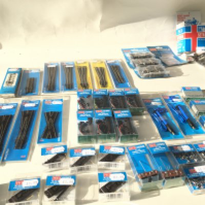 A collection of of PECO N gauge track pieces and also motors and accessories from PECO Lectrics . All unopened in original packaging. No reserve