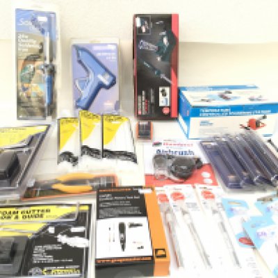 A collection of new and unopened tools used for modelling..including soldering irons..hot glue gun with glue..Airbrush..Foam cutter etc. no reserve