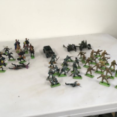 A collection of Britains Deetail model figures featuring Scaracens.. German WWII soldiers and British soldiers. Also diecast kubelwaggen and 2 artillery guns. No reserve