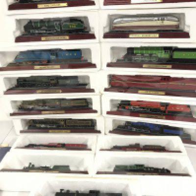 A Collection of 17 Boxed Atlas Model Trains with Magazines.
