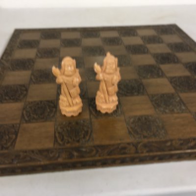 Wooden chess board with moulded pieces in Chinese style. Some damage noted to pieces unwrapped. (2). No reserve
