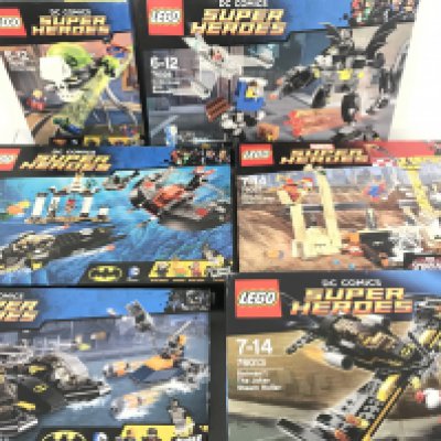 A Collection of 6 Boxed Lego Kits Including D.C. And Marvel. Kits Have Been Built.