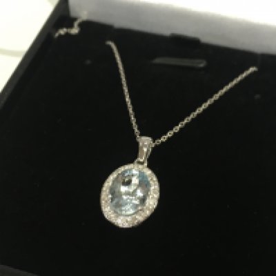 A 18ct white gold oval aquarmarine and RBC diamond cluster pendant on an 18ct white gold chain, boxed. Aquamarine 1.01ct , diamonds 0.32ct. 