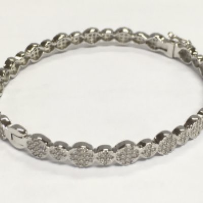 Silver bangle set with clusters of round white cubic zirconia, with hinged opening and safety catch. 13.5g total weight. 