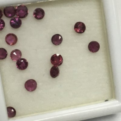 A parcel of 17 round cut rubies , totalling 3.25ct boxed