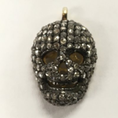 A gold plated silver diamond encrusted skull pendant , diamond 0.65ct approx