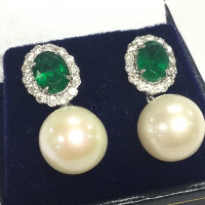 Pair of 18ct white gold cultured pearl , emerald and diamond droplets earrings with trumpet style butterflies , boxed. Oval cut emeralds. 2.60ct RBC diamonds 0.80ct . 8.60g total weight. 