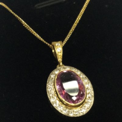 18ct yellow gold oval pendant set with a central oval cut pink sapphire and RBC diamonds on a yellow gold plated silver chain, boxed. Pink gem stone 3.80ct approx . Diamonds 0.60ct approx 