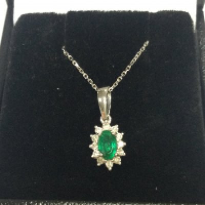 9ct white gold oval emerald and RBC diamond cluster pendant on a 9ct white gold chain, boxed. Emerald 0.22ct , diamonds 0.12ct 