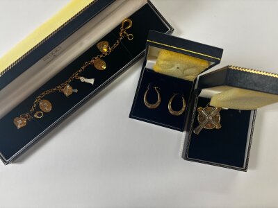 Boxed Brooks and Bentley jewellery including a pair of 9 carat gold earrings 0.9g total weight , cross pendant on chain, charm bracelet.