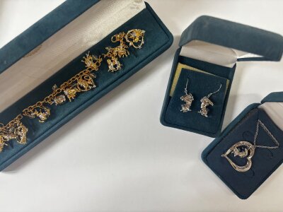 Three boxed Disney Bradford Exchange jewellery items including a pair of earrings, necklace and a bracelet