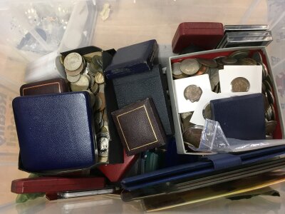 A large box of mixed coins including many silver coins