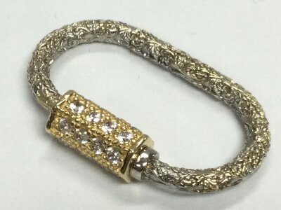 A unmarked 14ct white and yellow gold hand made lock clasp pendant . 5.14g total weight.
