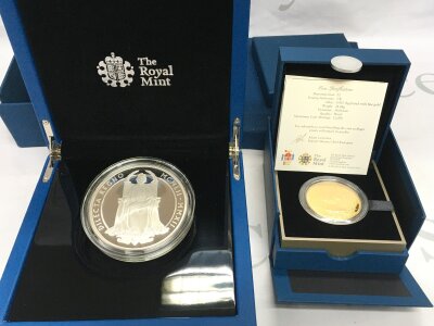 A 5oz silver queen jubilee coin and a 925 silver with gold plate coin.
