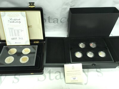 A silver crown set feasting gold plating and a silver proof colour 50p set.