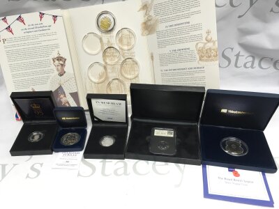 A collection of assorted silver coins including the royal British legion silver poppy coin and a Churchill £20 silver coin.