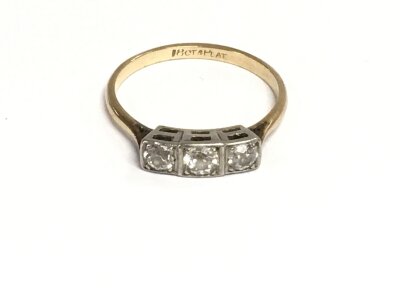 An 18ct gold and platinum three stone diamond ring. Size S and 3.01g