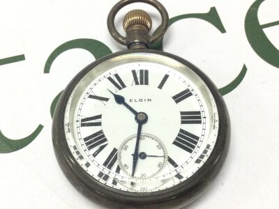 An Elgin pocket watch, seen working.