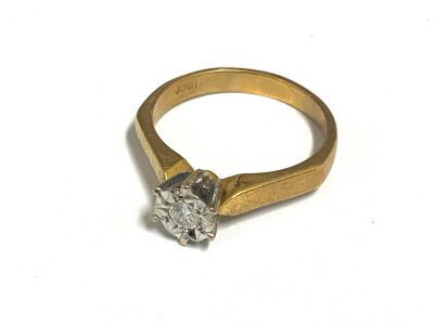 An 18ct yellow gold illusion set solitaire diamond ring, Size M.