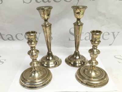 Two pairs of weighted silver candlesticks, tallest approx 20cm. London hallmarks.