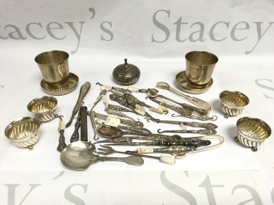 A collection of silver comprising button hooks, salts, toddy cups, spoon etc.
