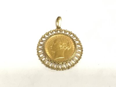 An 1884 young head Victoria full sovereign within a 9ct gold mount, approx 10.8g.