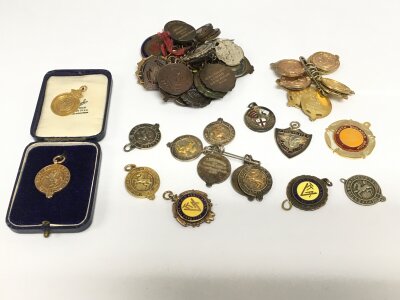 A large collection of 9ct gold, silver and bronze cyclist medals.
