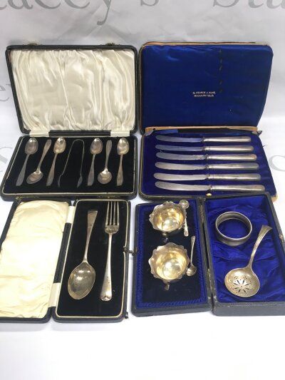A collection of cased silver items comprising a set of tea spoons, cruets etc.